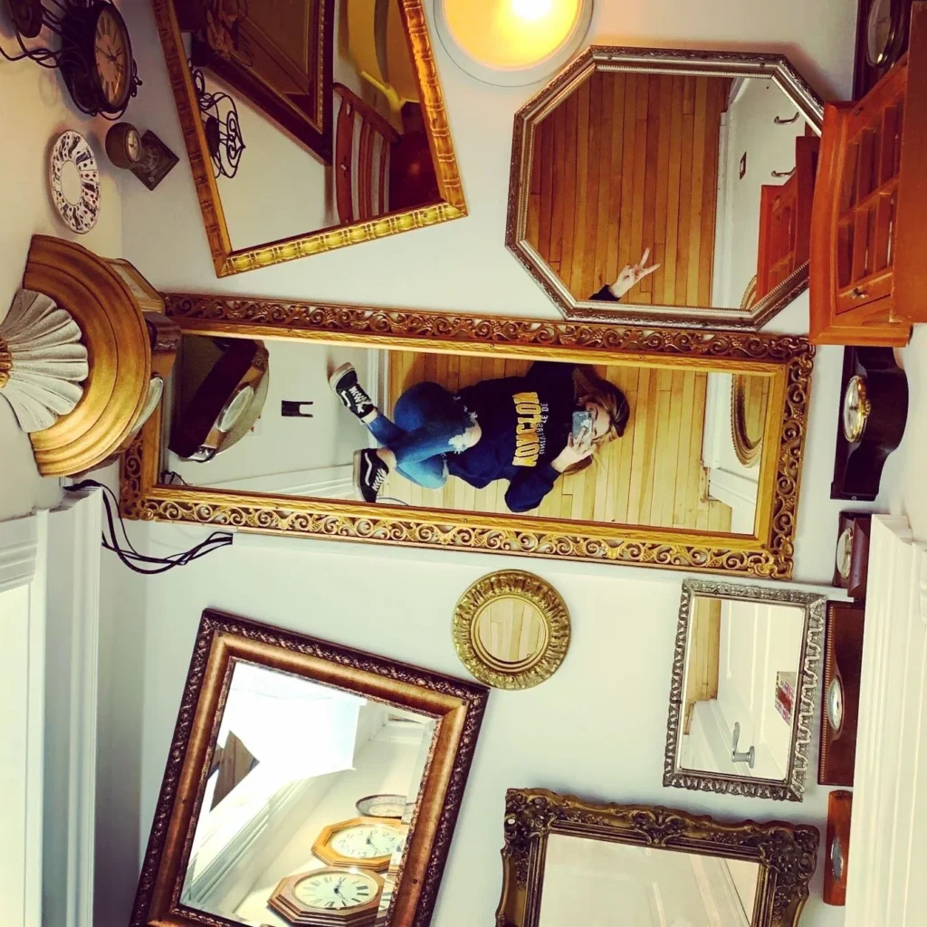 Gilded mirrors of every shape on a dining room wall